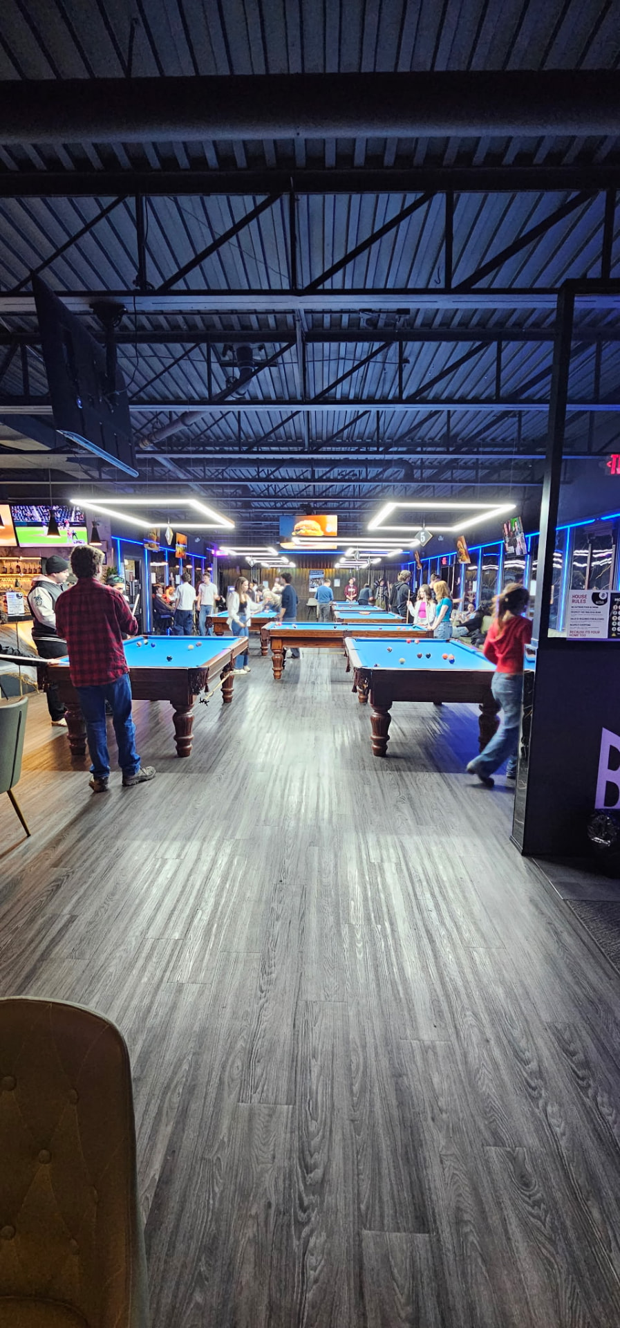 Blue felt Boston pool tables filled with players at King Billiards