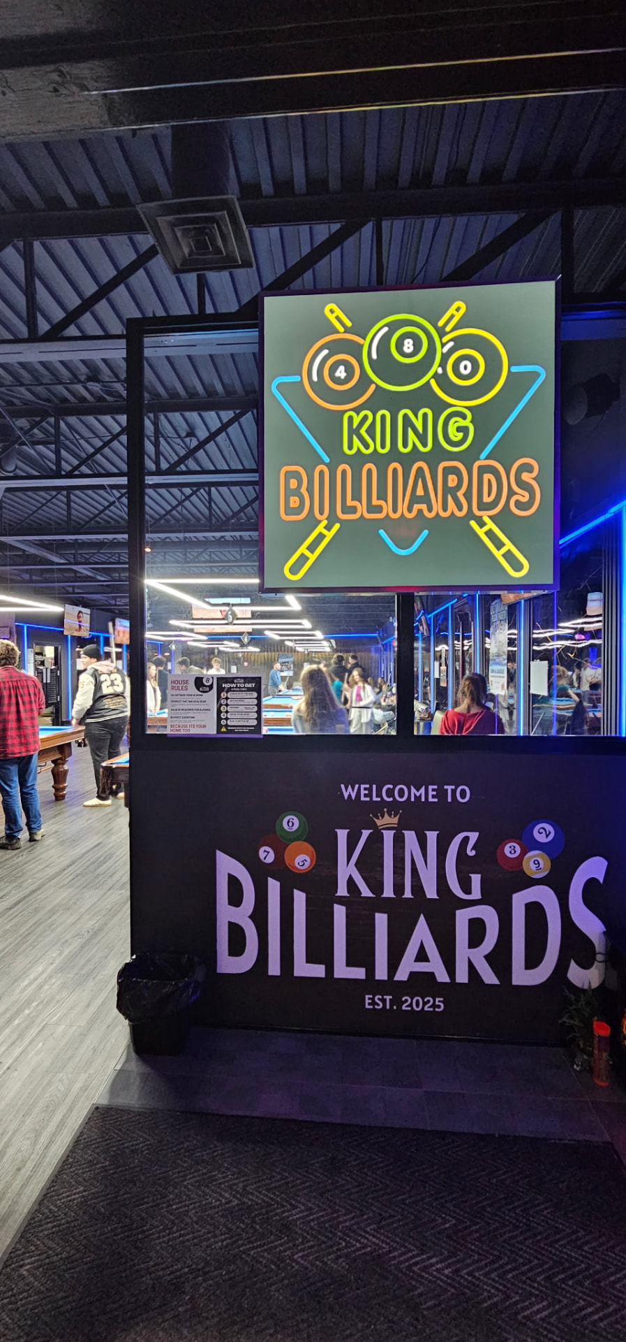 Neon Welcome to King Billiards sign at the entrance